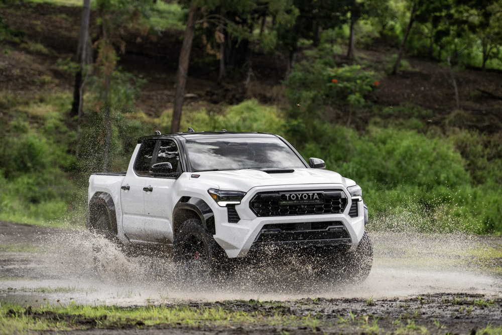 White 2024 Toyota Tacoma driving through water