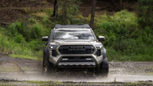 Gray 2024 Toyota Tacoma driving through water