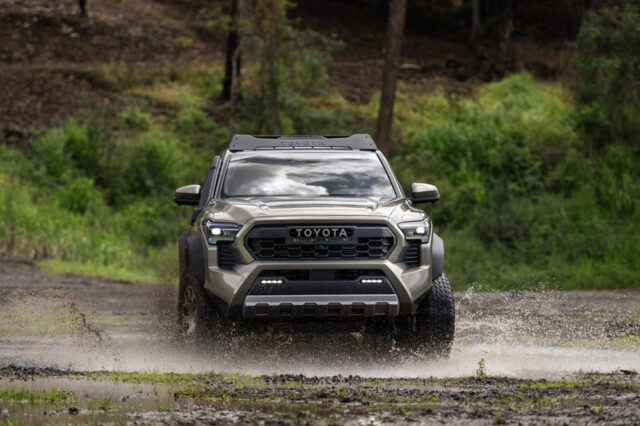 Gray 2024 Toyota Tacoma driving through water